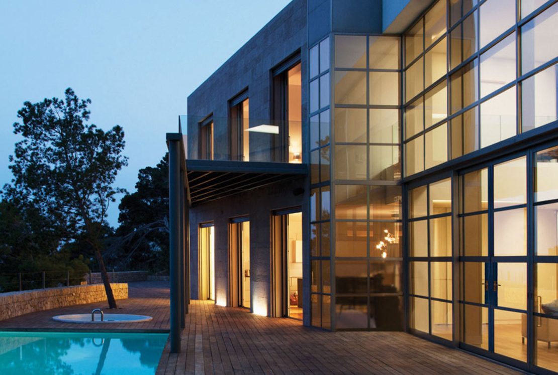 modern home with floor to ceiling aluco doors and windows